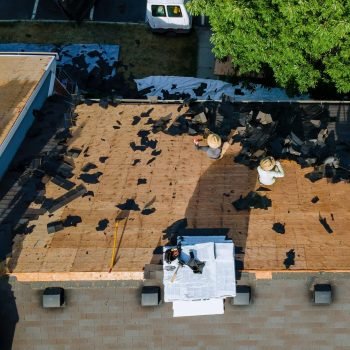 Working roofers on replacing the roof of residential building in the renovation roof the house